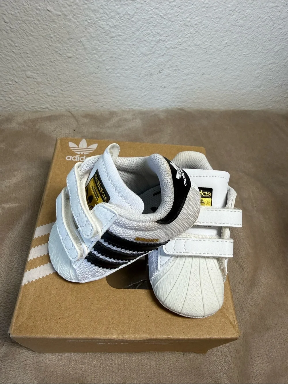 Adidas Superstar Crib shoes in Cloud White and Core Black